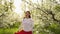 beautiful young woman walks by flowering trees. natural cosmetics and perfumes.