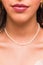 Beautiful young woman wearing a pearl necklace and golden earings.  Beautiful valentine`s gift
