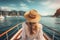 Beautiful young woman in white dress and straw hat sitting on the deck of a yacht and looking at the sea, A beautiful tourist