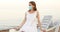 beautiful young woman in a white summer dress and a medical mask
