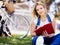 Beautiful young woman writing in her diary outdoors