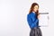 Beautiful young woman in yellow glasses holds documents on white background, teacher, blank space for copy