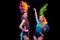 Beautiful young women in carnival and masquerade costume in colorful neon lights on black background