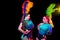 Beautiful young women in carnival and masquerade costume in colorful neon lights on black background