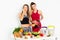 Beautiful young women eating healthy fruits and vegetables on white background . Diet concept. - Image