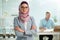 Beautiful young working woman in hijab and eyeglasses smiling in office