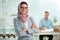 Beautiful young working woman in hijab and eyeglasses smiling in office