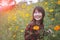 Beautiful younger asian woman toothy smiling face with happiness emotion standing in yellow cosmost flower field