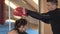 Beautifull brunette woman kickboxing workout with a trainer in fitness gym. Slow motion. Strong and gorgeous woman. Hard workout.