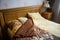 Beautifull linens, pillows and blankets on brown wooden bed and