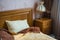 Beautifull linens, pillows and blankets on brown wooden bed and