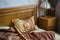 Beautifull linens, pillows and blankets on brown wooden bed and