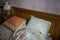 Beautifull linens, pillows and blankets on brown wooden bed and