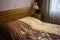 Beautifull linens, pillows and blankets on brown wooden bed and