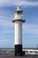 Beautifull small iron lighthouse on the `Oosterstaketsel` pier along the Belgian coast in Blankenberge, Belgium