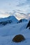 Beautifull view to snow mountains and tent on the glacier on sunset