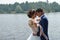 Beautifull wedding couple kissing and embracing near lake