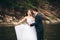 Beautifull wedding couple kissing and embracing near the shore of a mountain river with stones