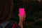Beautifull young girls hand holding smartphone with blank screen. pink screen