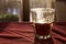 A beautifully backlit glass of red soft drink on a restaurant table