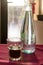 A beautifully backlit glass of red soft drink on a restaurant table