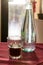 A beautifully backlit glass of red soft drink on a restaurant table