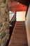 Beautifully carpeted staircase with wood ceilings and stone fireplace