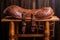 a beautifully crafted leather saddle on wooden bench