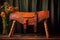 a beautifully crafted leather saddle on wooden bench