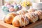 Beautifully decorated Easter bread with white frosting and pastel colored eggs. Easter celebration with family at home.