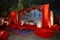 Beautifully decorated red sofas or couch ready for the guests sitting at a wedding ceremony in backyard, night ceremony venue,