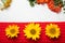 Beautifully decorated still life, red layout, warm scarf, yellow flowers, sunflowers, mountain ash. On a white