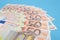 Beautifully folded euro banknotes on a blue background. Financial concept