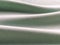 Beautifully folded light green fabric. Soft pleasant waves and flounces on textiles. Close-up. Drapery for curtains, fabric for