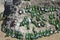 Beautifully laid out empty beer bottles on a huge boulder in a sunny weather.