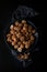 Beautifully presented walnuts on dark slate plate kitchen table