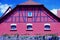 Beautifully renovated cowshed with red half-timbered facade and red roof under a blue sky   2