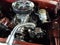 A beautifully restored classic car engine with chrome parts.