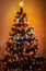 Beautifully romantic decorated Christmas tree with Multi Colored Lights on warm background.
