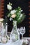 Beautifully served wedding table decorated with designer vases with bouquets.