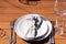 Beautifully served wooden table without a tablecloth. White plates on a wooden table