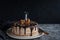 Beautifully styled and decorated birthday cake with one candle blown out, on a table, oranges, walnut and chocolate decoration,