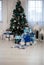 beautifully, stylishly decorated Christmas tree for New Year party and packed gifts next to it