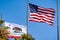 Beautifully waving star and striped American flag and the Republic of California flag on a