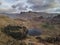 Beautiufl unique drone aerial sunrise landscape image of Blea Tarn and Langdales Range in UK Lake District