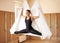 Beautiul inspired girl doing aerial yoga on white hammock in the studio