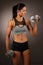 Beautuful hispanic woman workout with dumbbells studio portrait