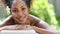 Beauty african woman lying on massage table at spa