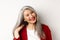 Beauty and aging concept. Close up of asian senior woman with red lips, long healthy grey hair, smiling at camera