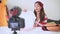 Beauty Asian Vlogger blogger interview with professional DSLR digital camera film video live. Woman coaching trading and review